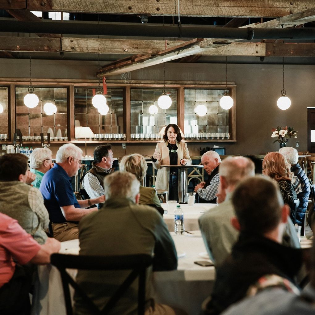 Speaker addressing a corporate luncheon at The Dahlia